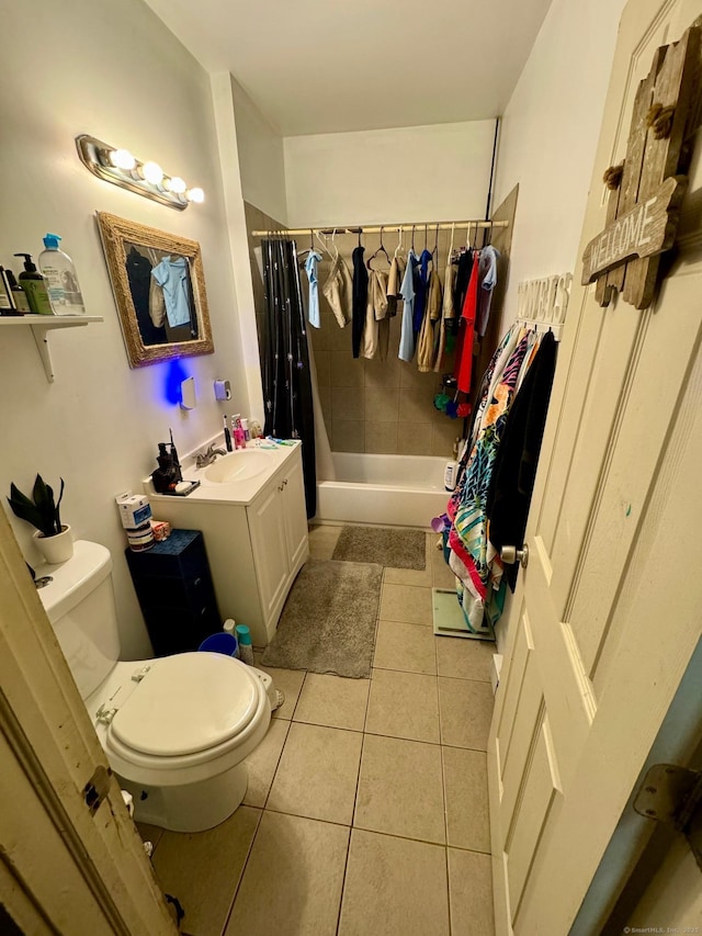 bathroom featuring tile patterned floors, toilet, vanity, and shower / bathtub combination with curtain