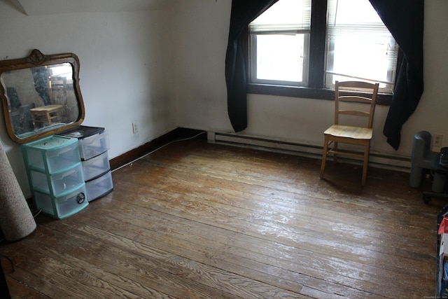 bedroom with baseboards, wood-type flooring, and baseboard heating