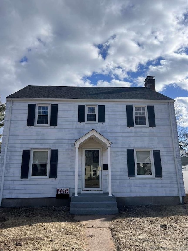 colonial home featuring a chimney