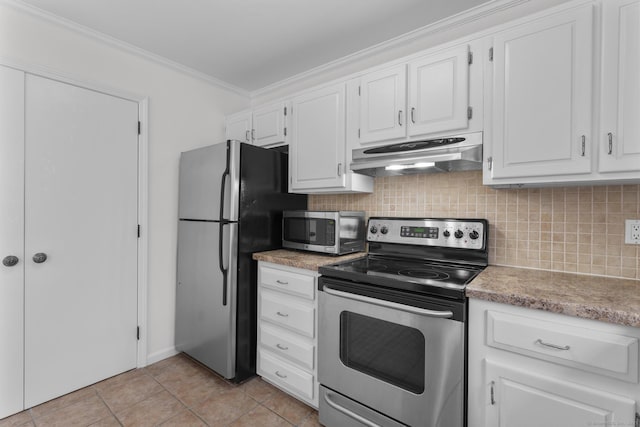 kitchen with crown molding, under cabinet range hood, decorative backsplash, stainless steel appliances, and white cabinetry