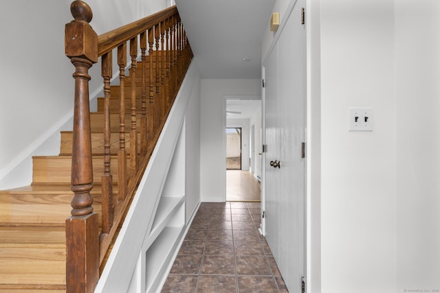 staircase with tile patterned flooring and baseboards