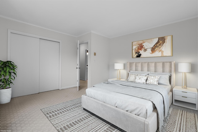 bedroom featuring a closet, carpet floors, and ornamental molding