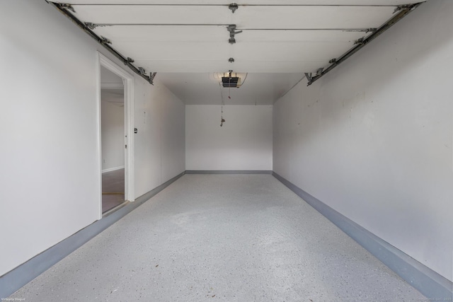 garage featuring baseboards and a garage door opener