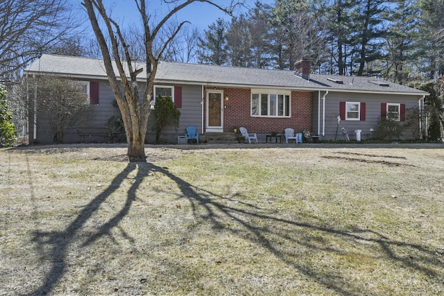 single story home featuring a front lawn, brick siding, a chimney, and a shingled roof