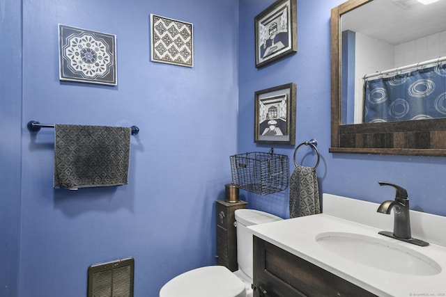 bathroom featuring vanity, curtained shower, toilet, and heating unit