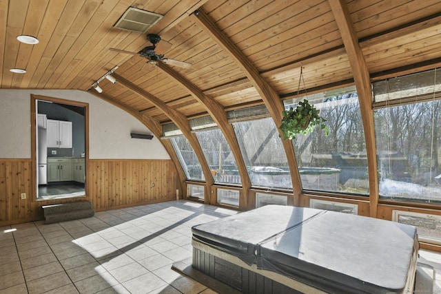 unfurnished sunroom with visible vents, wood ceiling, rail lighting, and vaulted ceiling