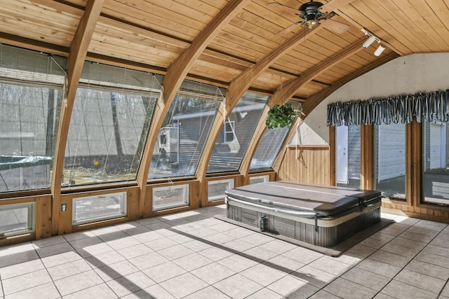 unfurnished sunroom with lofted ceiling, rail lighting, and wood ceiling