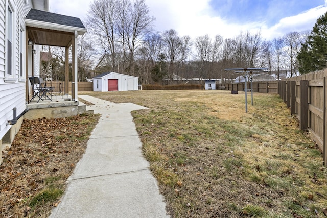 view of yard featuring an outbuilding and fence