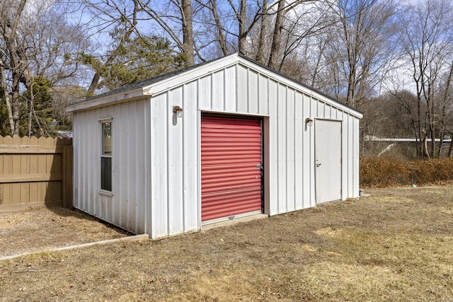 view of outbuilding with an outbuilding and fence