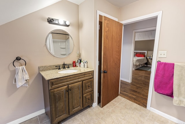 bathroom featuring tile patterned floors, vanity, and baseboards