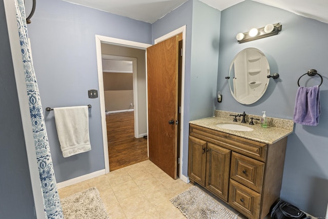 full bath featuring tile patterned floors, baseboards, and vanity