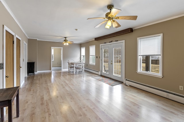 unfurnished living room with french doors, baseboard heating, a healthy amount of sunlight, and crown molding