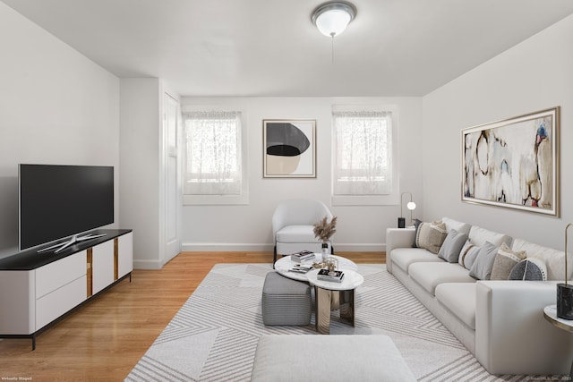 living room featuring light wood-style flooring and baseboards