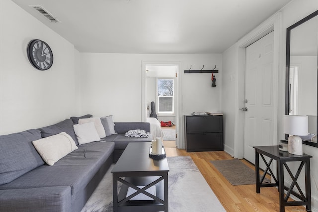 living room featuring visible vents and light wood finished floors