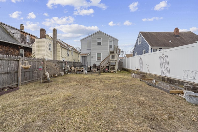 view of yard with a vegetable garden and a fenced backyard