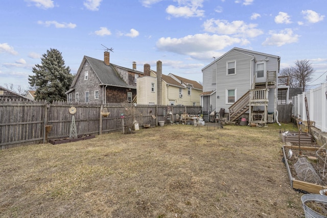 rear view of property with a yard and a fenced backyard