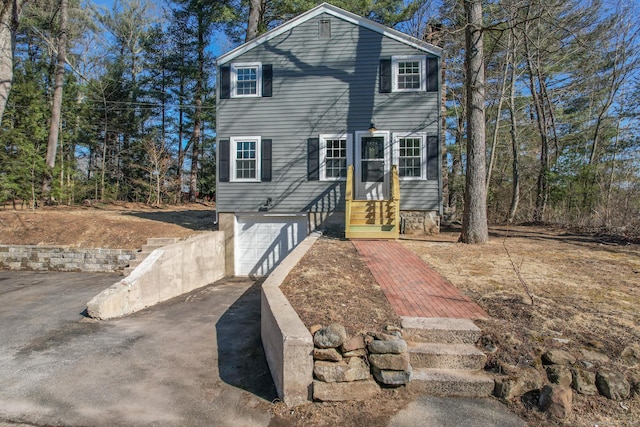 view of front of home featuring a garage, driveway, and entry steps