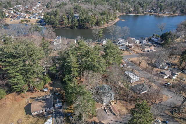 birds eye view of property with a water view and a wooded view