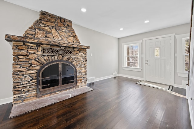 unfurnished living room with recessed lighting, visible vents, baseboards, and dark wood-style flooring