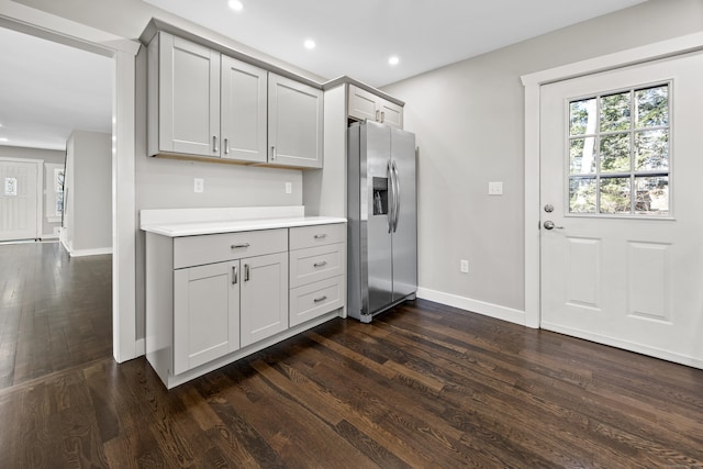 kitchen with gray cabinetry, baseboards, recessed lighting, stainless steel refrigerator with ice dispenser, and dark wood-style floors