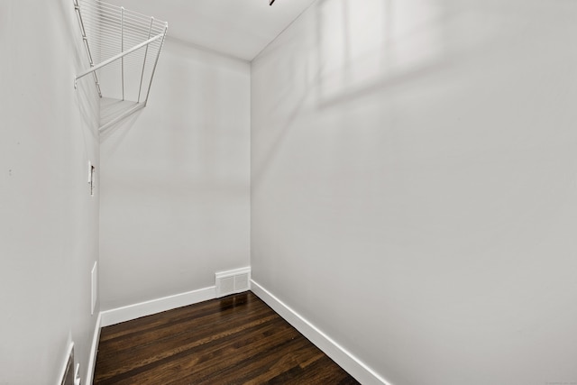 walk in closet featuring dark wood-style floors and visible vents