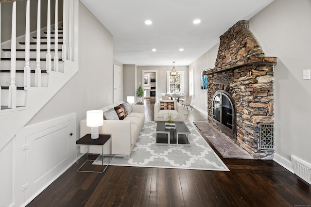 unfurnished living room featuring stairway, visible vents, baseboards, recessed lighting, and hardwood / wood-style flooring