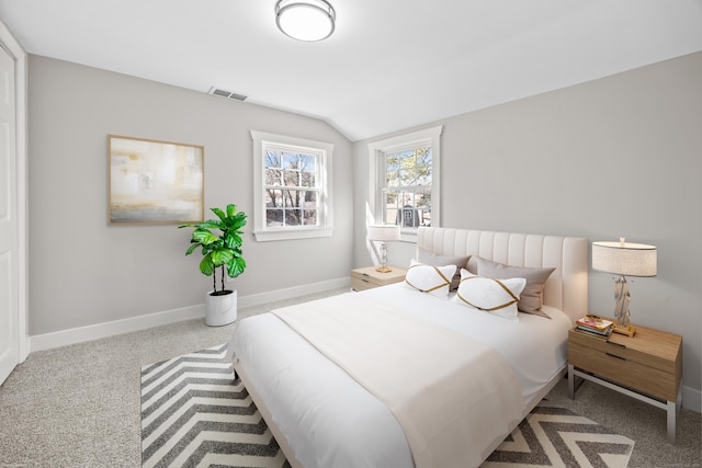 carpeted bedroom with visible vents, baseboards, and vaulted ceiling