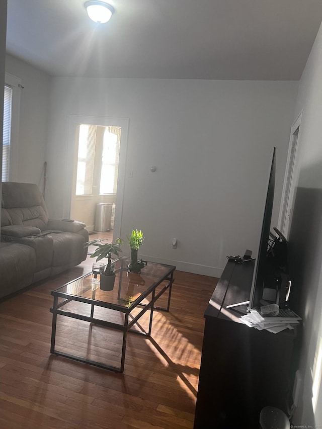 living area with wood finished floors and baseboards