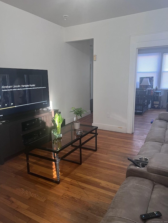 living room featuring baseboards and wood finished floors