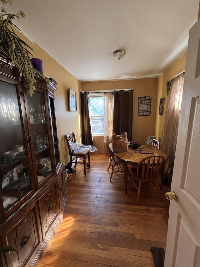 dining area with dark wood-style flooring