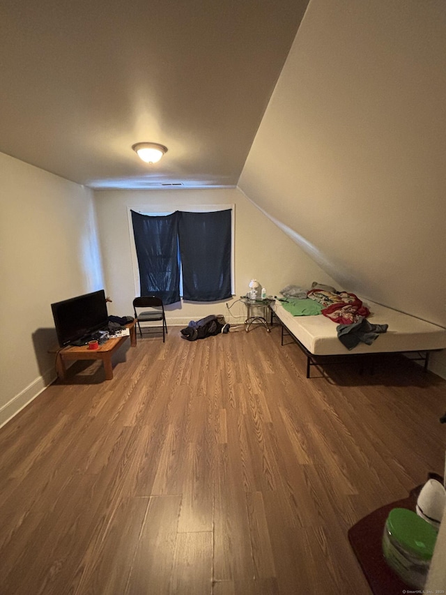 interior space featuring lofted ceiling and wood finished floors