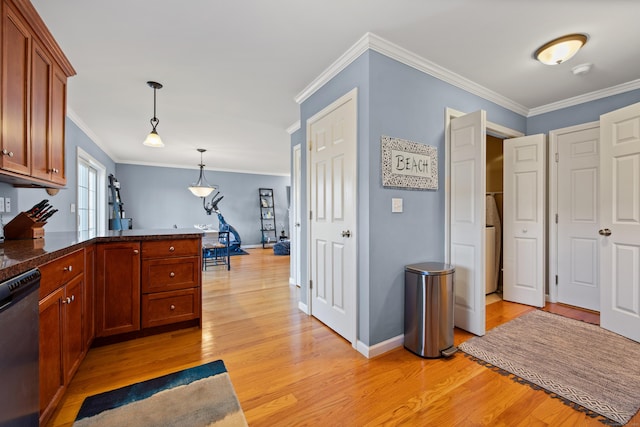 kitchen with light wood finished floors, decorative light fixtures, dark countertops, and stainless steel dishwasher