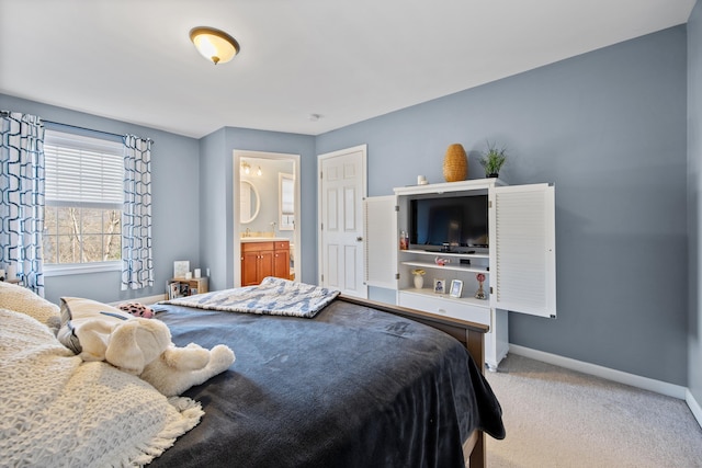 carpeted bedroom featuring baseboards and ensuite bath