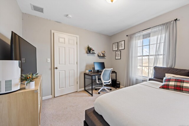 bedroom featuring visible vents, baseboards, and carpet