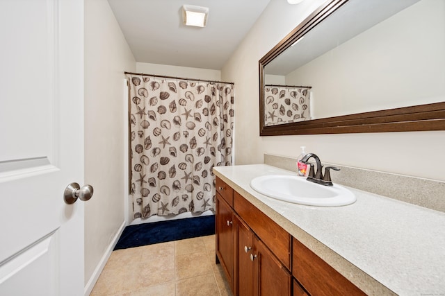 full bath featuring a shower with shower curtain, baseboards, vanity, and tile patterned flooring