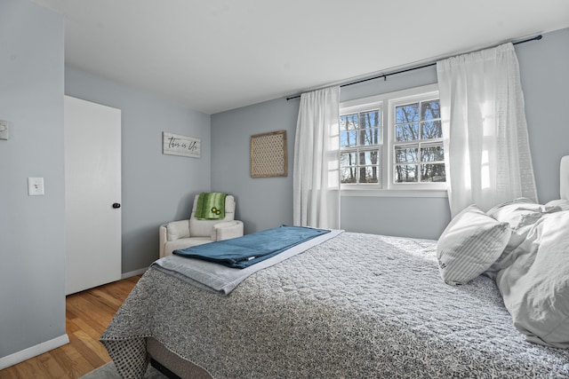 bedroom featuring wood finished floors and baseboards