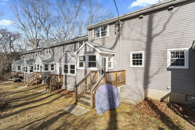 rear view of property with a wooden deck