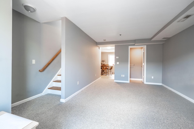 interior space featuring visible vents, baseboards, stairs, and carpet