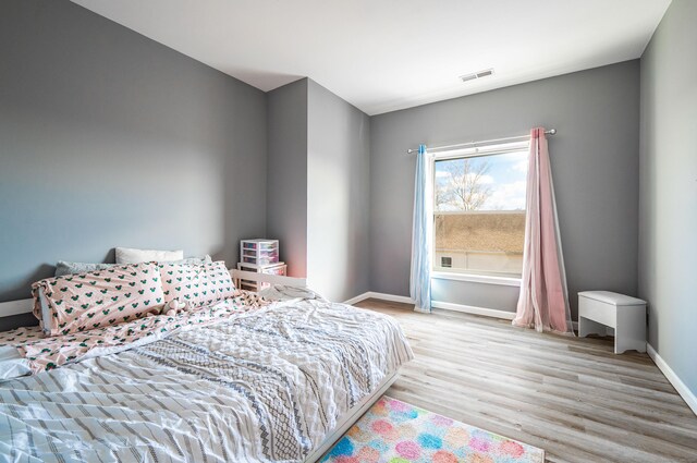 bedroom featuring visible vents, baseboards, and light wood-type flooring