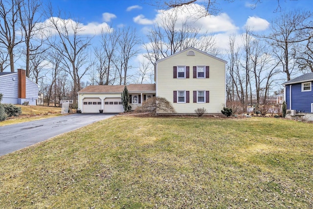 view of front facade with aphalt driveway, a front lawn, a garage, and fence