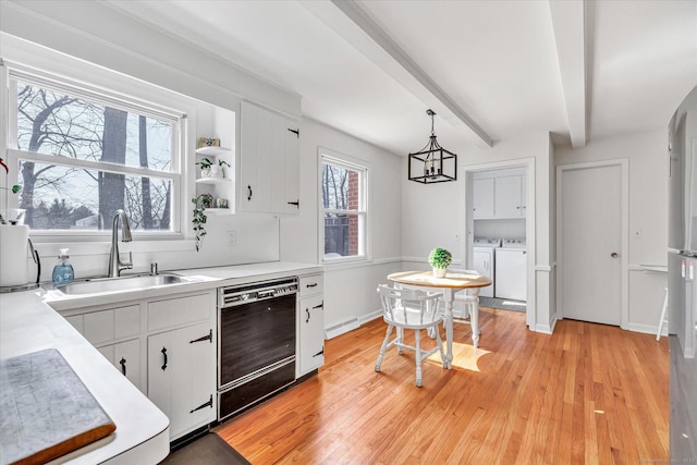 kitchen featuring washer and dryer, beam ceiling, a sink, dishwasher, and baseboard heating