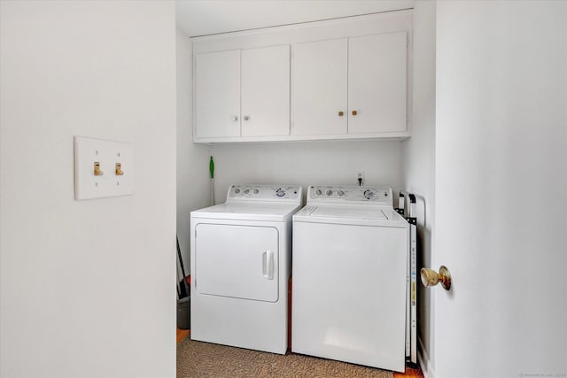 washroom featuring cabinet space and washing machine and dryer