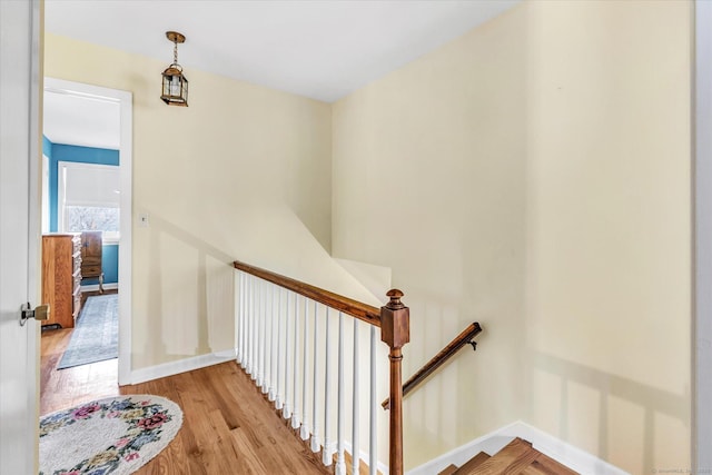 stairs featuring baseboards and wood finished floors