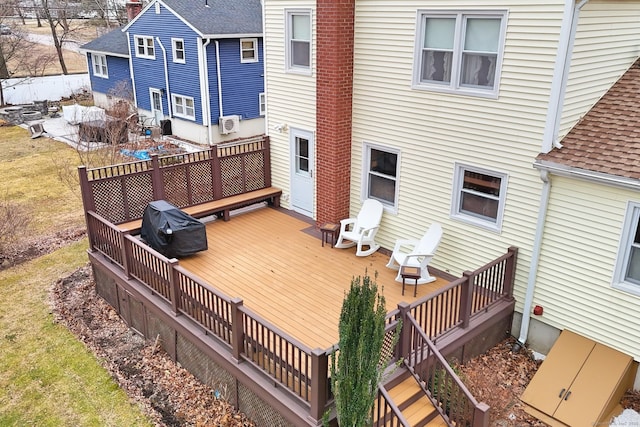 wooden terrace with a grill