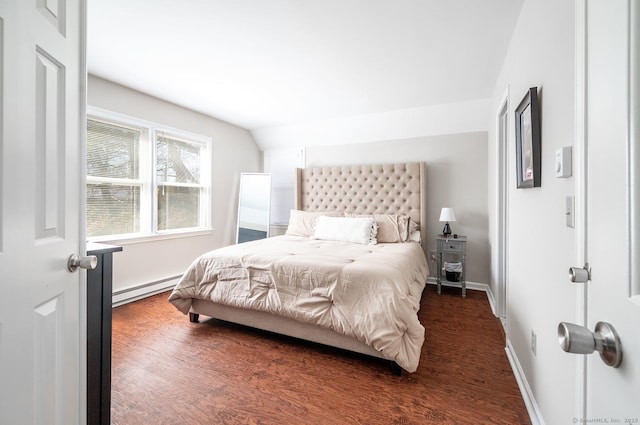 bedroom featuring baseboard heating, lofted ceiling, baseboards, and wood finished floors