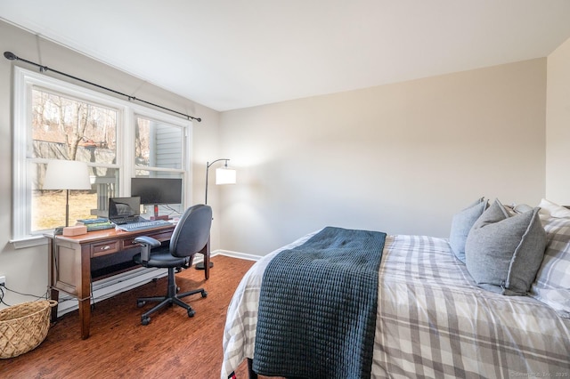 bedroom featuring baseboards and wood finished floors