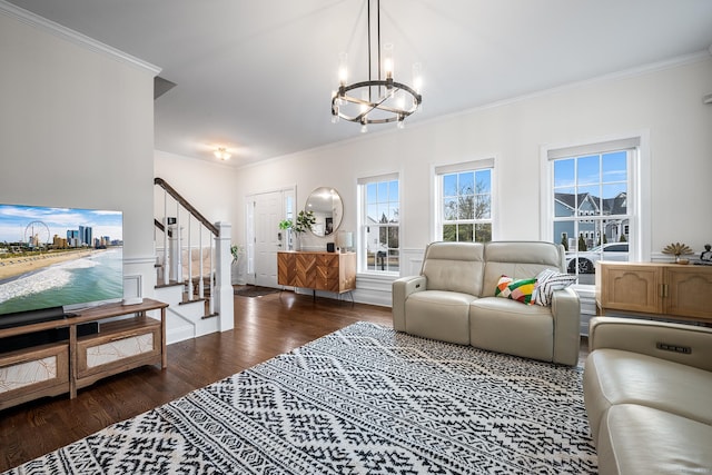 living area featuring a chandelier, stairway, crown molding, and wood finished floors