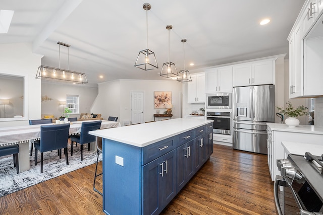 kitchen featuring light countertops, appliances with stainless steel finishes, white cabinets, blue cabinets, and dark wood-style flooring