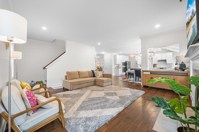 living room with dark wood finished floors, recessed lighting, stairs, and crown molding