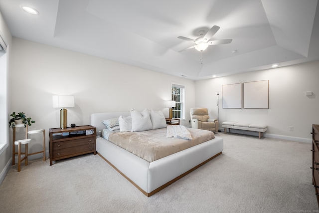 bedroom with baseboards, carpet floors, recessed lighting, a raised ceiling, and a ceiling fan